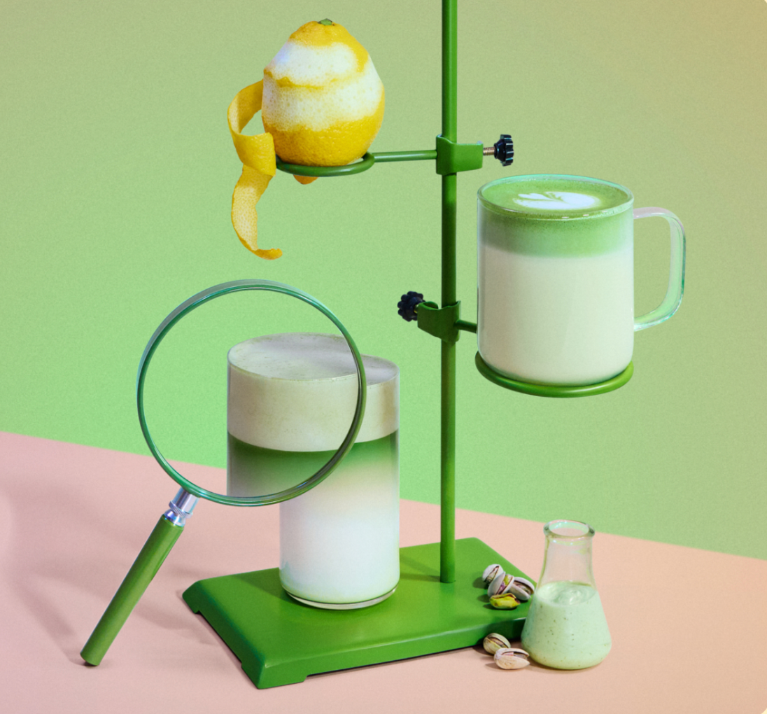 PCR Coffee Cupping Spoon product shot in a colorful studio with a lemon, magnifying glass, and a mug with green foam