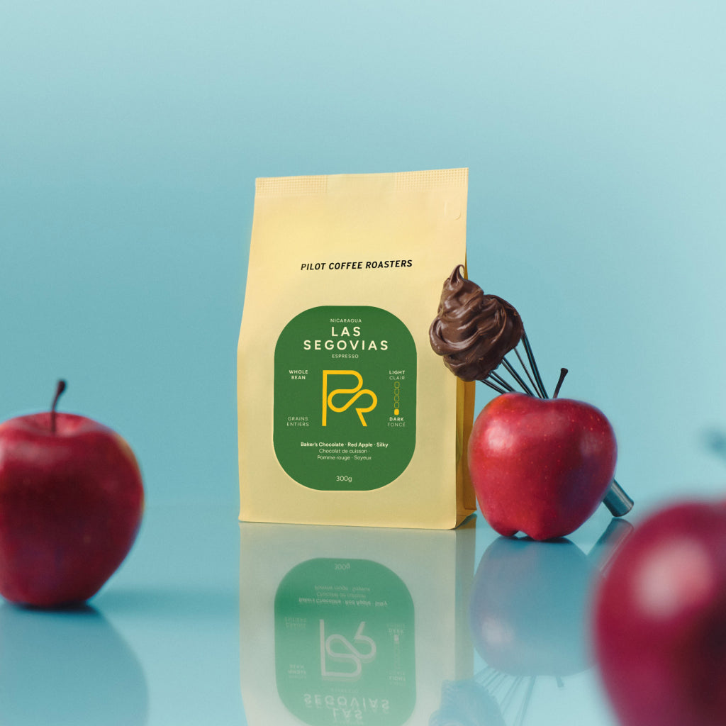 Las Segovias coffee package with red apples on a blue background