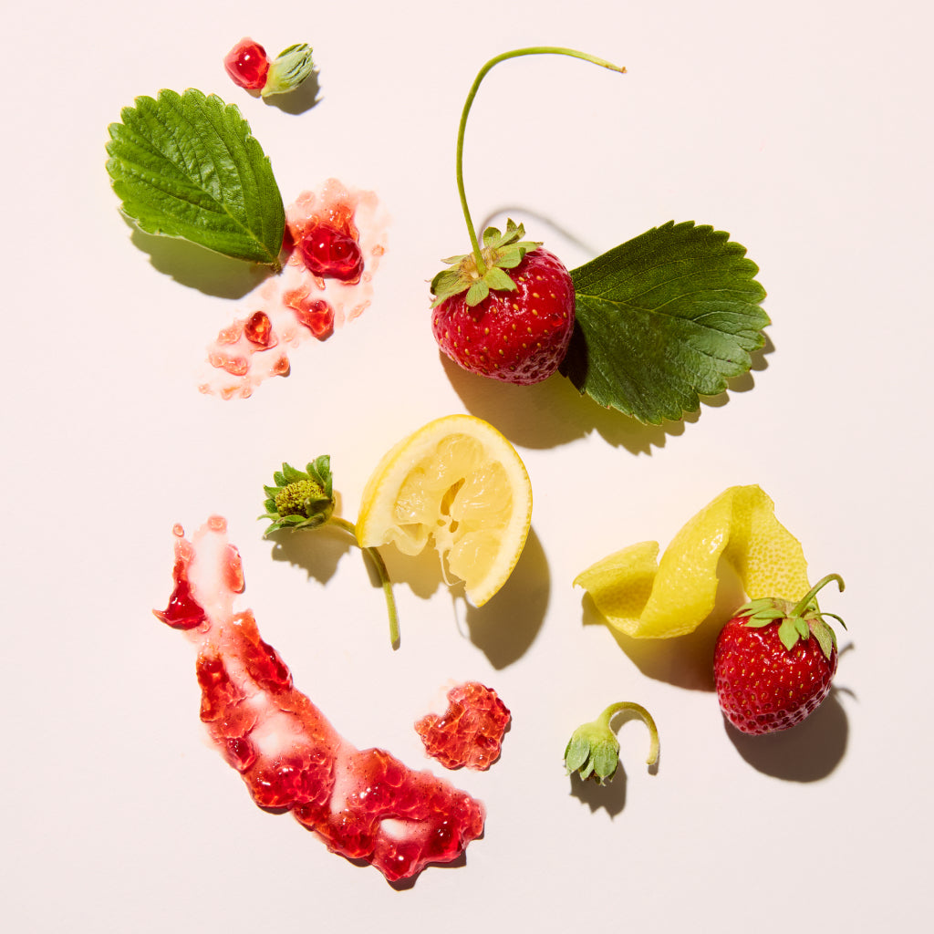 Strawberries and lemon pieces arranged in a circular pattern on a light background